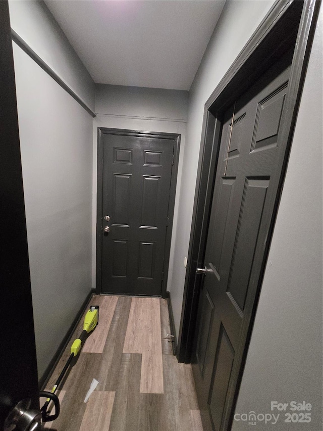 hallway with light hardwood / wood-style flooring