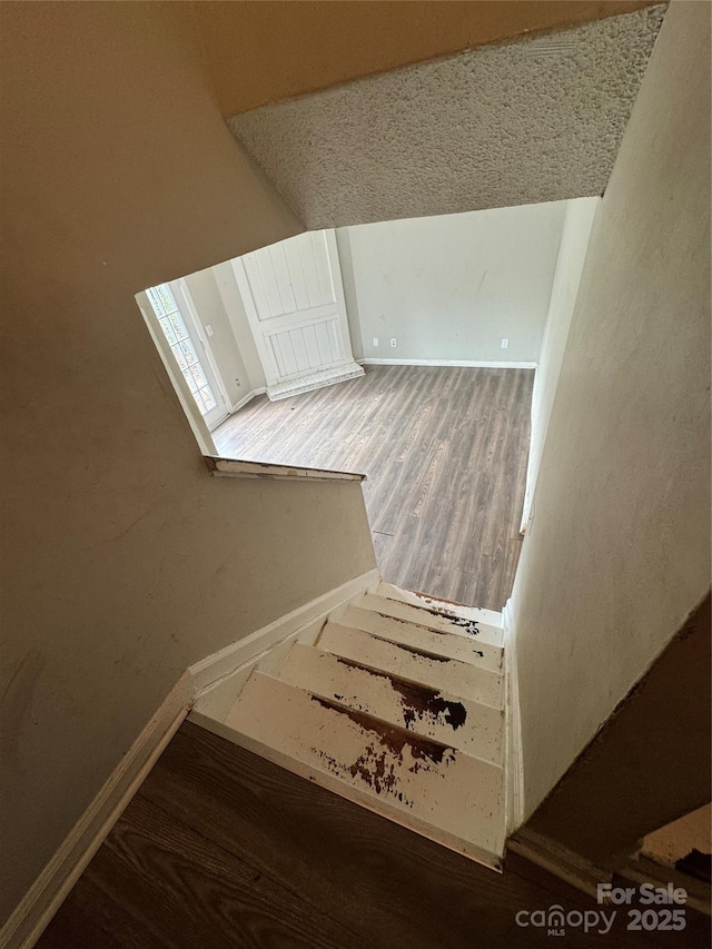 stairs featuring hardwood / wood-style floors