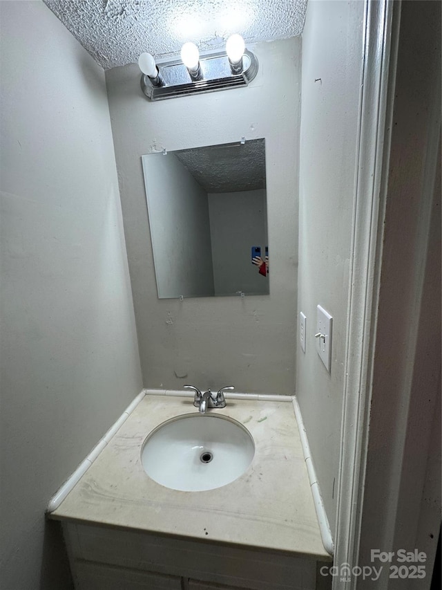 bathroom featuring vanity and a textured ceiling