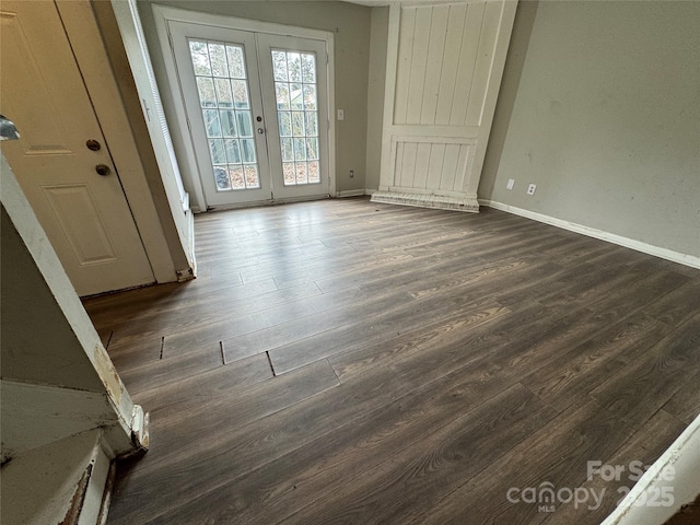 empty room with french doors and dark hardwood / wood-style floors