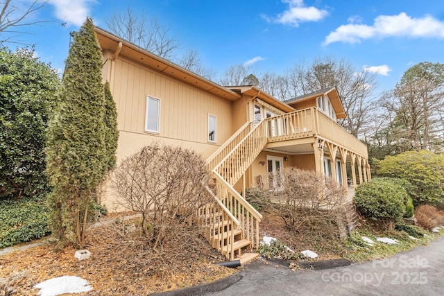 view of side of home featuring a wooden deck