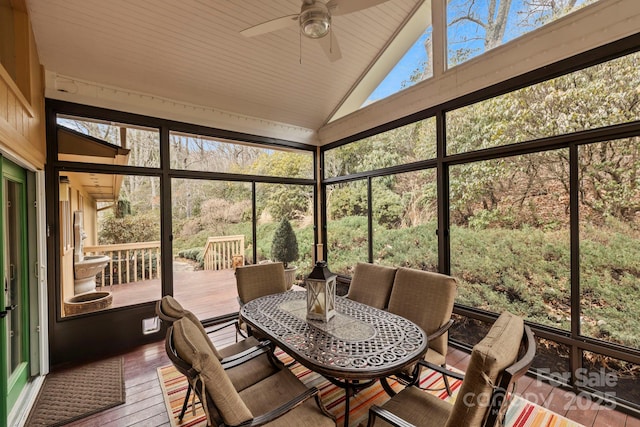 sunroom / solarium with lofted ceiling and ceiling fan