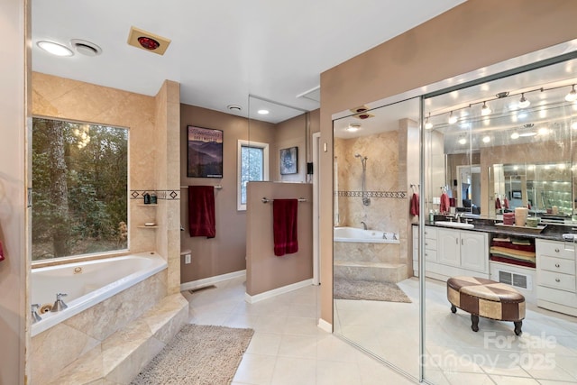 bathroom featuring vanity, tile patterned flooring, and plus walk in shower