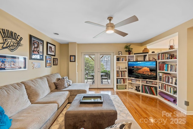 living room featuring hardwood / wood-style flooring, ceiling fan, and french doors