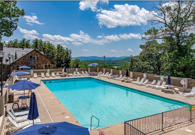 view of pool with a mountain view and a patio area