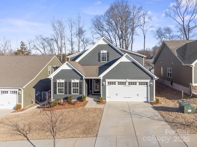 view of front of home with concrete driveway and a shingled roof