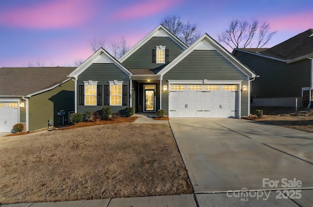 view of front facade with concrete driveway and a garage