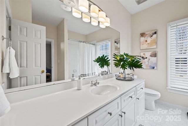 bathroom with vanity, toilet, and tile patterned floors