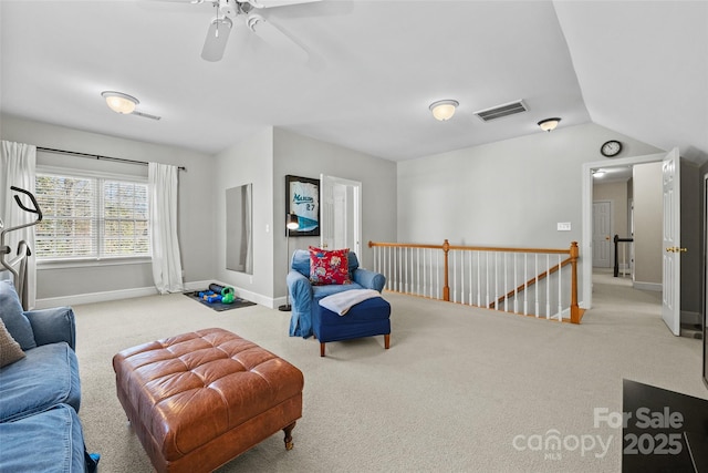 living area featuring vaulted ceiling and carpet floors