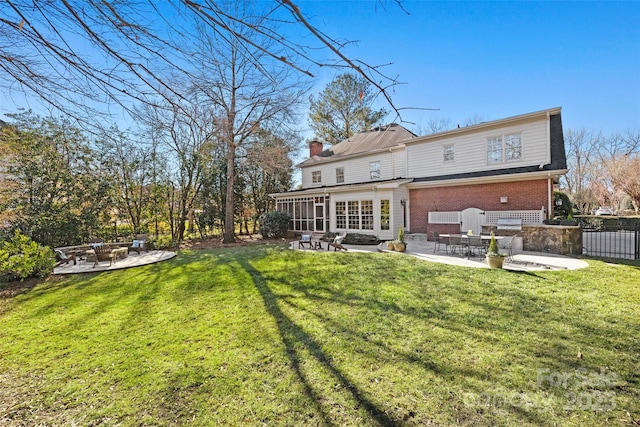 rear view of property with a patio area and a yard