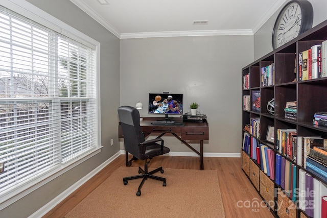 home office featuring crown molding and light wood-type flooring