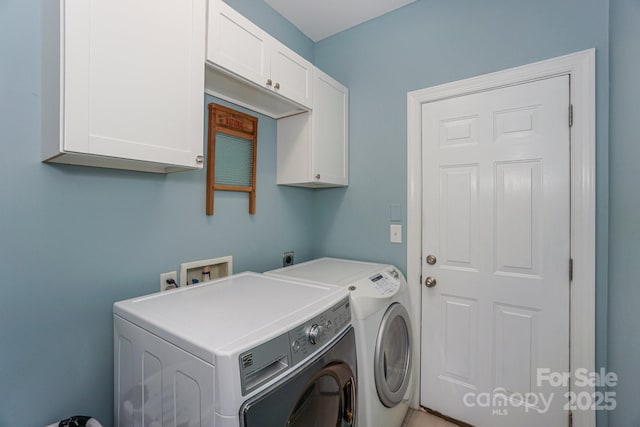 laundry area featuring independent washer and dryer and cabinets