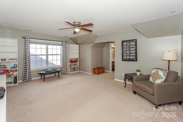 sitting room featuring light carpet, vaulted ceiling, and ceiling fan