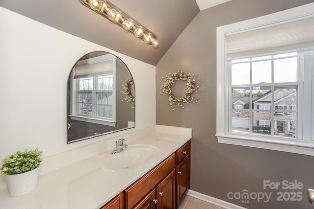 bathroom with vanity and lofted ceiling