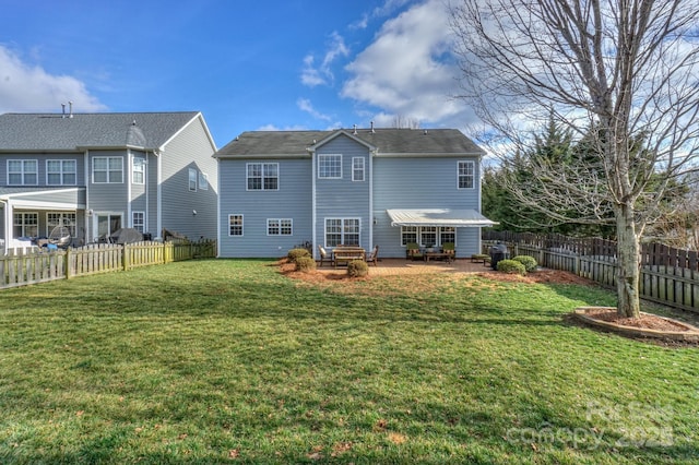 rear view of property with a lawn and a patio area