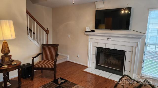 living area featuring hardwood / wood-style flooring and a fireplace