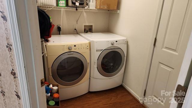 washroom with washer and clothes dryer and dark hardwood / wood-style floors