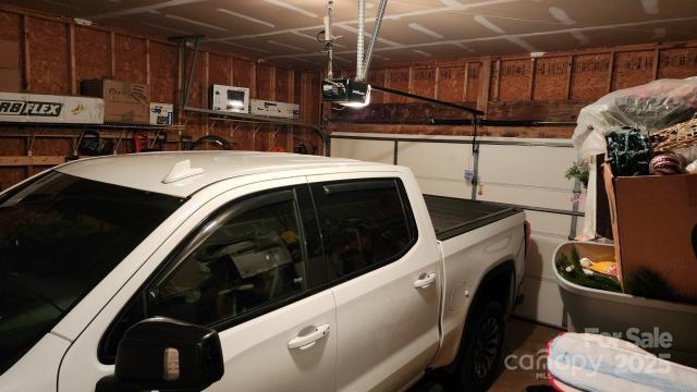 garage with a garage door opener and washer / dryer