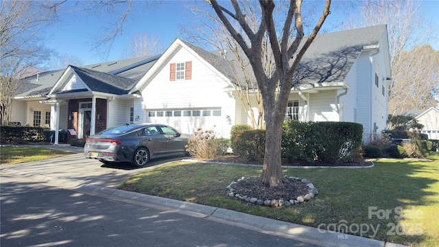 view of front of home with a garage and a front yard