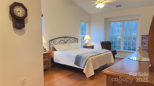 bedroom featuring wood-type flooring, lofted ceiling, and ceiling fan