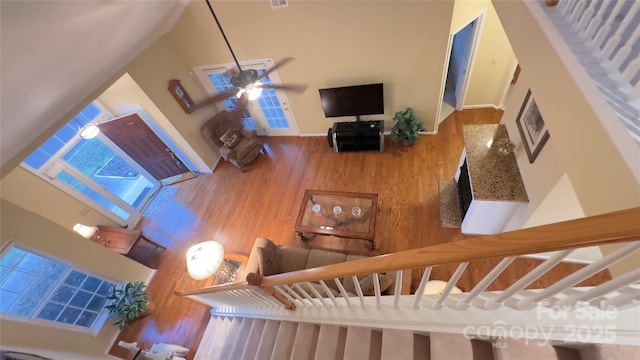 living room with wood-type flooring and ceiling fan