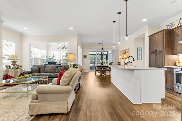 living room with crown molding, dark hardwood / wood-style floors, and a chandelier