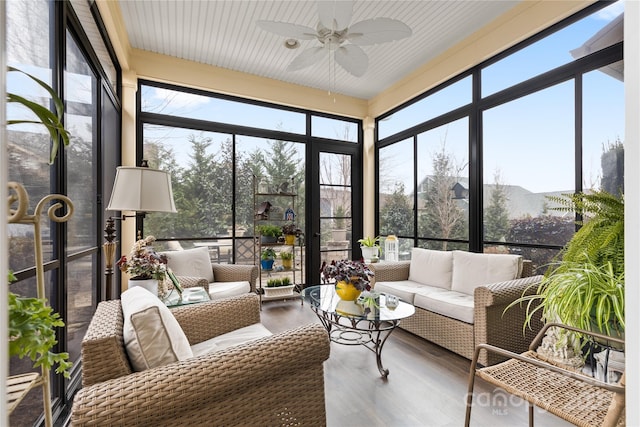 sunroom / solarium featuring a wealth of natural light and ceiling fan