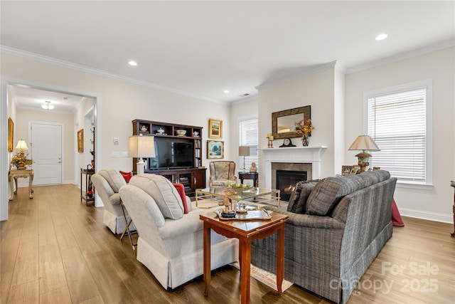 living room with ornamental molding and light hardwood / wood-style floors