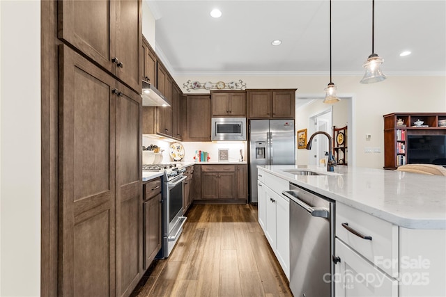 kitchen featuring sink, white cabinets, hanging light fixtures, stainless steel appliances, and crown molding