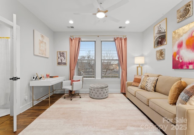 living room featuring hardwood / wood-style floors and ceiling fan