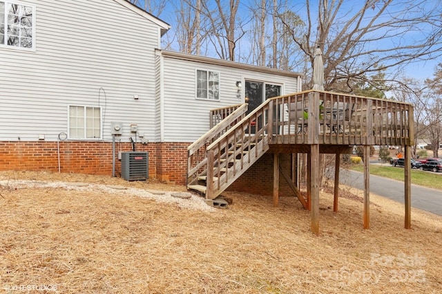 back of house with a deck and central air condition unit