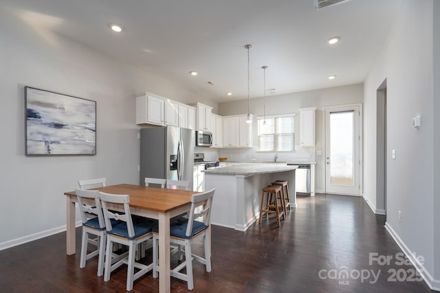 dining area with sink and dark hardwood / wood-style flooring