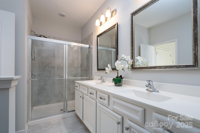 bathroom featuring vanity, a shower with shower door, and tile patterned flooring