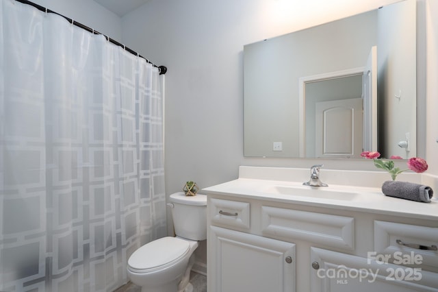 bathroom with toilet, vanity, and a shower with curtain