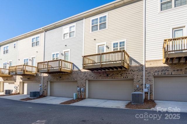 back of property featuring a balcony and central AC unit