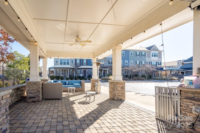 view of patio with an outdoor living space and ceiling fan