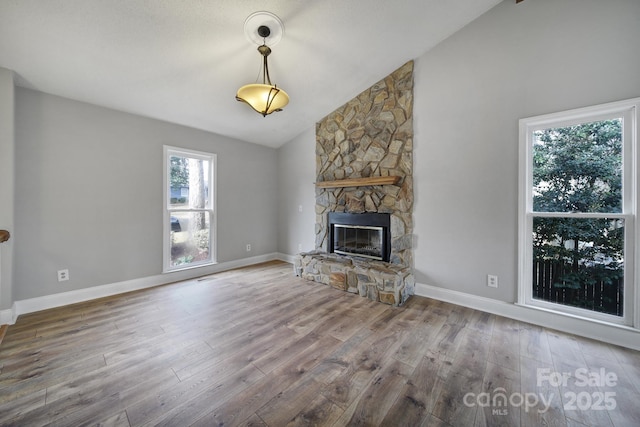 unfurnished living room with a fireplace, hardwood / wood-style flooring, and vaulted ceiling