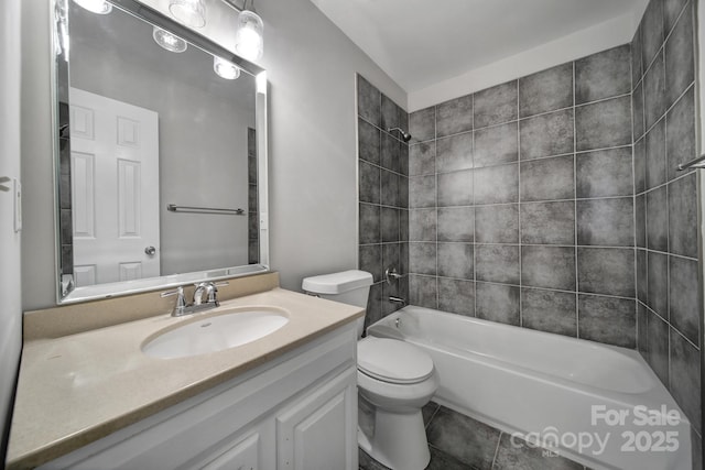 full bathroom featuring vanity, tile patterned flooring, tiled shower / bath combo, and toilet