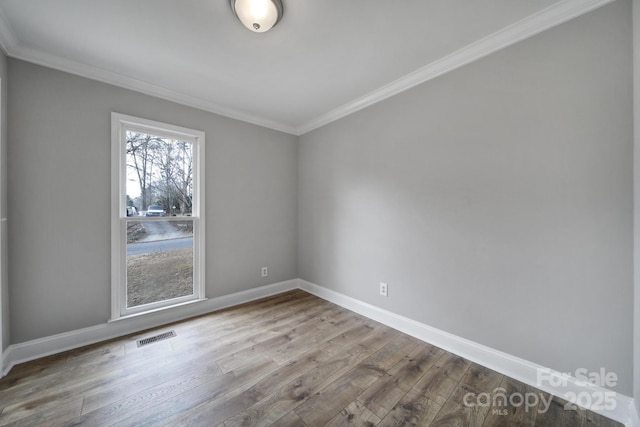 unfurnished room featuring crown molding and light hardwood / wood-style flooring