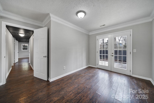 unfurnished room with dark wood-type flooring, ornamental molding, french doors, and a textured ceiling