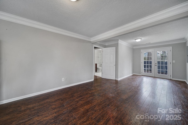 spare room with dark wood-type flooring, ornamental molding, french doors, and a textured ceiling