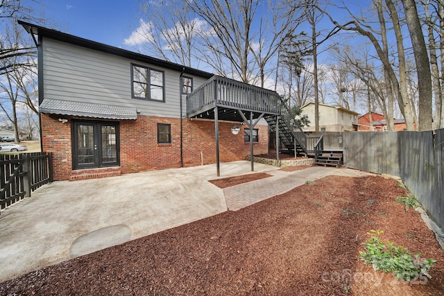 rear view of house featuring a deck and a patio area