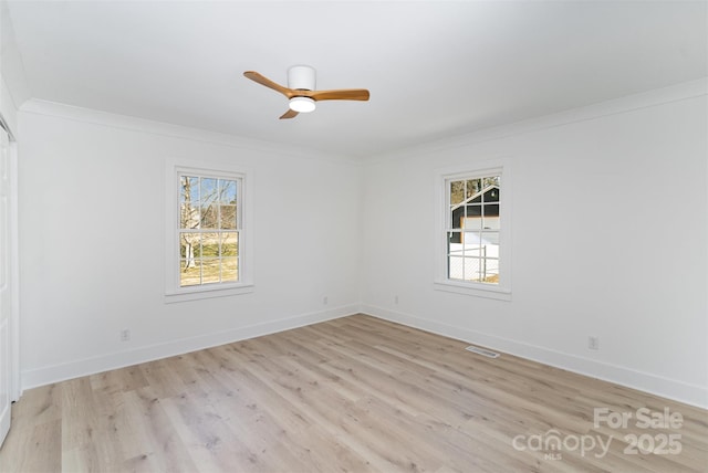 empty room featuring ceiling fan, light hardwood / wood-style flooring, and crown molding