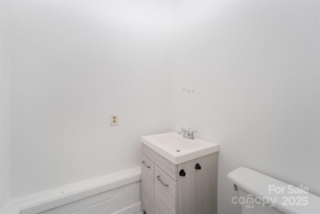 bathroom featuring toilet and vanity