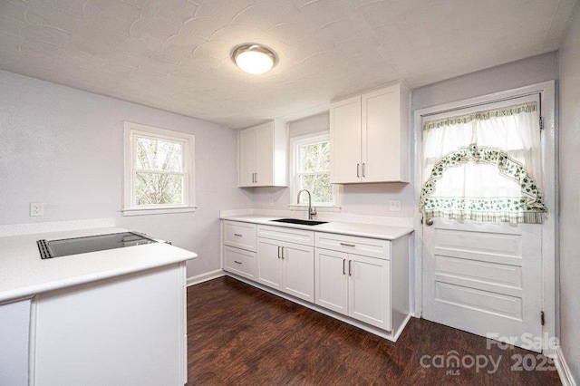 kitchen featuring dark hardwood / wood-style flooring, sink, white cabinetry, and plenty of natural light