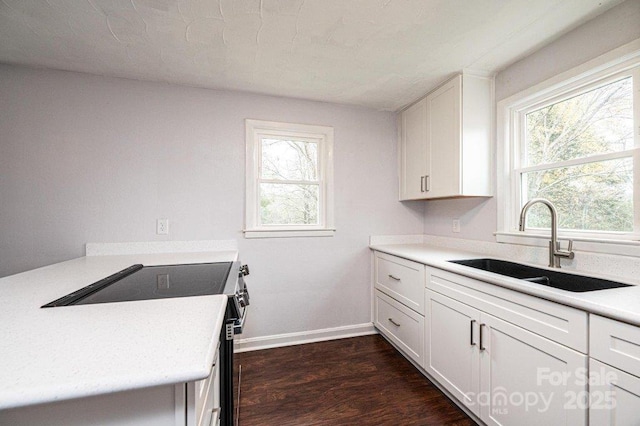 kitchen featuring white cabinetry, range with electric stovetop, dark hardwood / wood-style floors, and sink