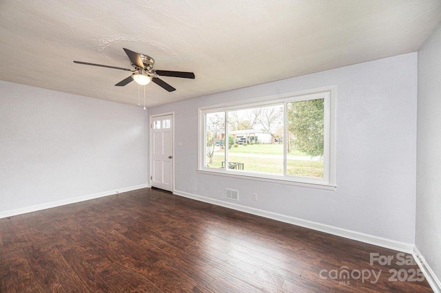 spare room featuring ceiling fan and dark hardwood / wood-style floors