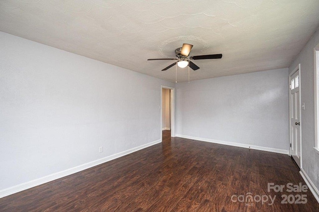 spare room featuring ceiling fan and dark hardwood / wood-style floors