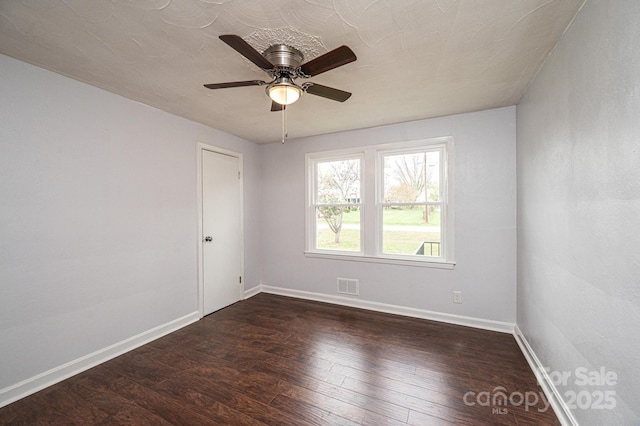 unfurnished room featuring ceiling fan and dark hardwood / wood-style flooring