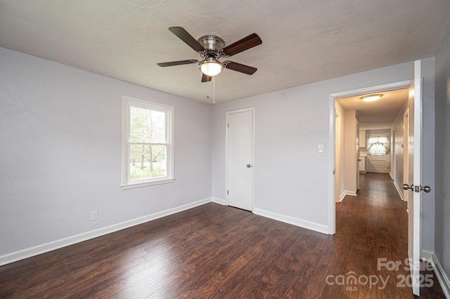 spare room featuring ceiling fan and dark hardwood / wood-style flooring